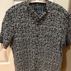 Men short sleeves black shirt with white pattern. New without a tag. Size XXL.